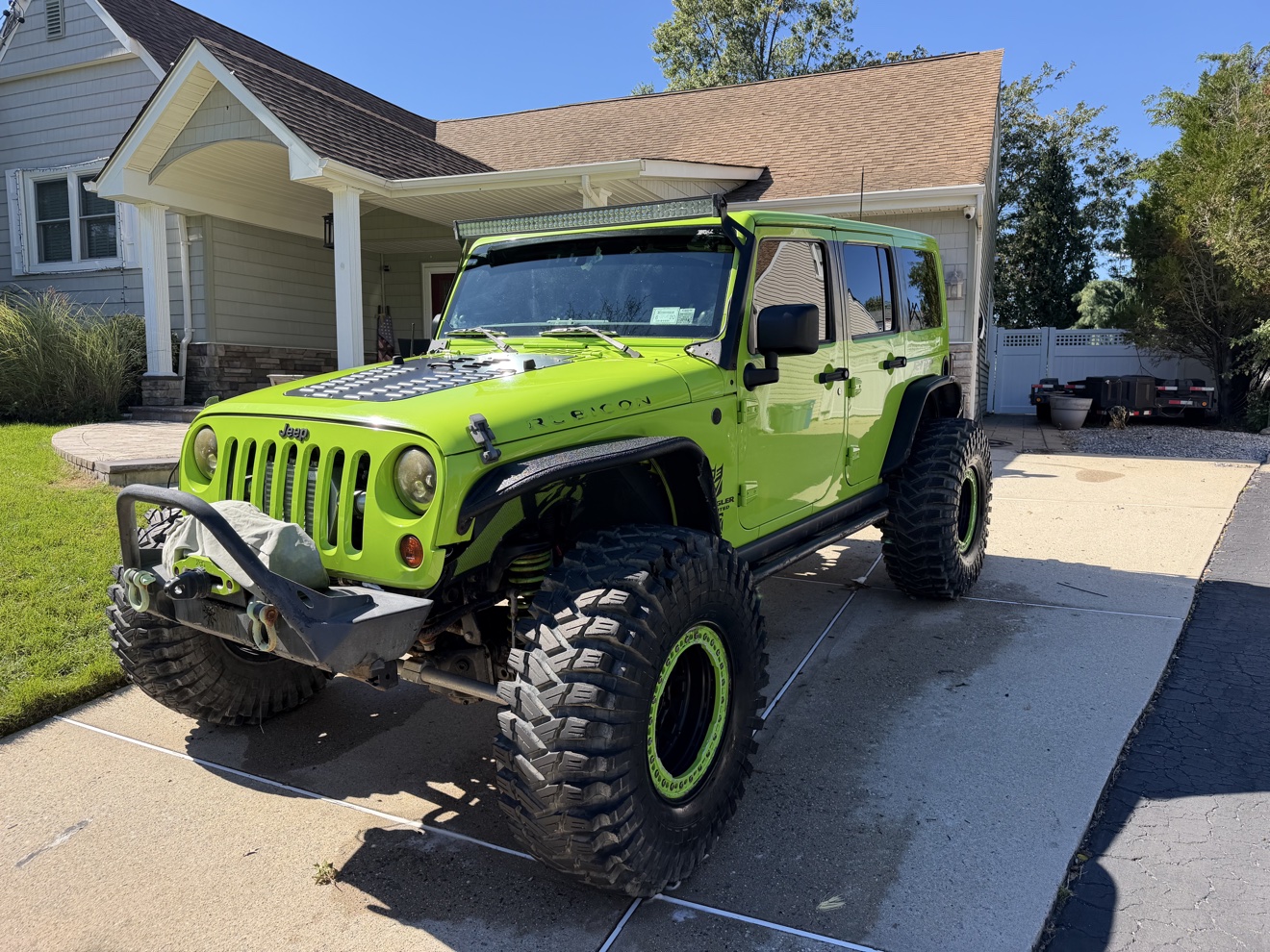Lifted lime green Jeep Wrangler after a wash